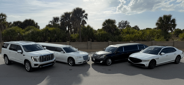 Four luxury vehicles parked near palm trees.